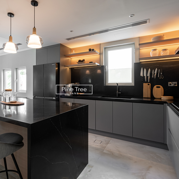 kitchen with matte grey cabinets and black marble countertops