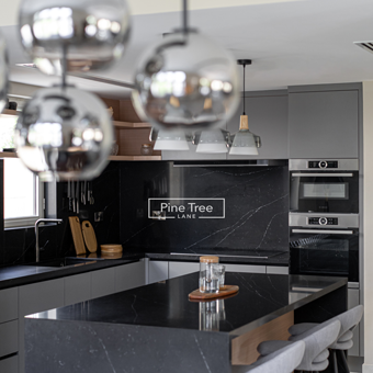 kitchen featuring open shelving with warm lighting