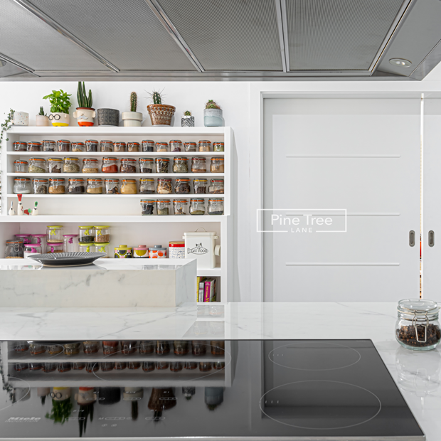White kitchen with marble countertops and smart storage