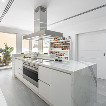 white cabinetry with integrated modern appliances