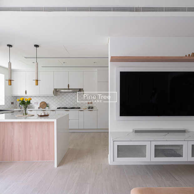 Modern kitchen with white cabinets and wood-accented island
