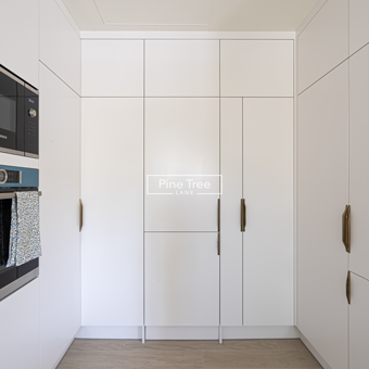 Kitchen with floor-to-ceiling white cabinetry