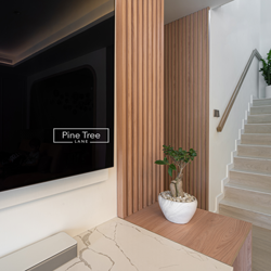 Sleek TV unit with subtle lighting and light wood textures