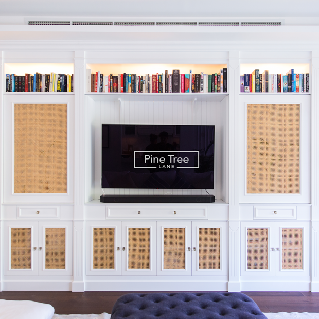 kitchen with paneling, wine storage, and integrated appliances