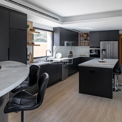 kitchen with black bar chairs and casual dining nook