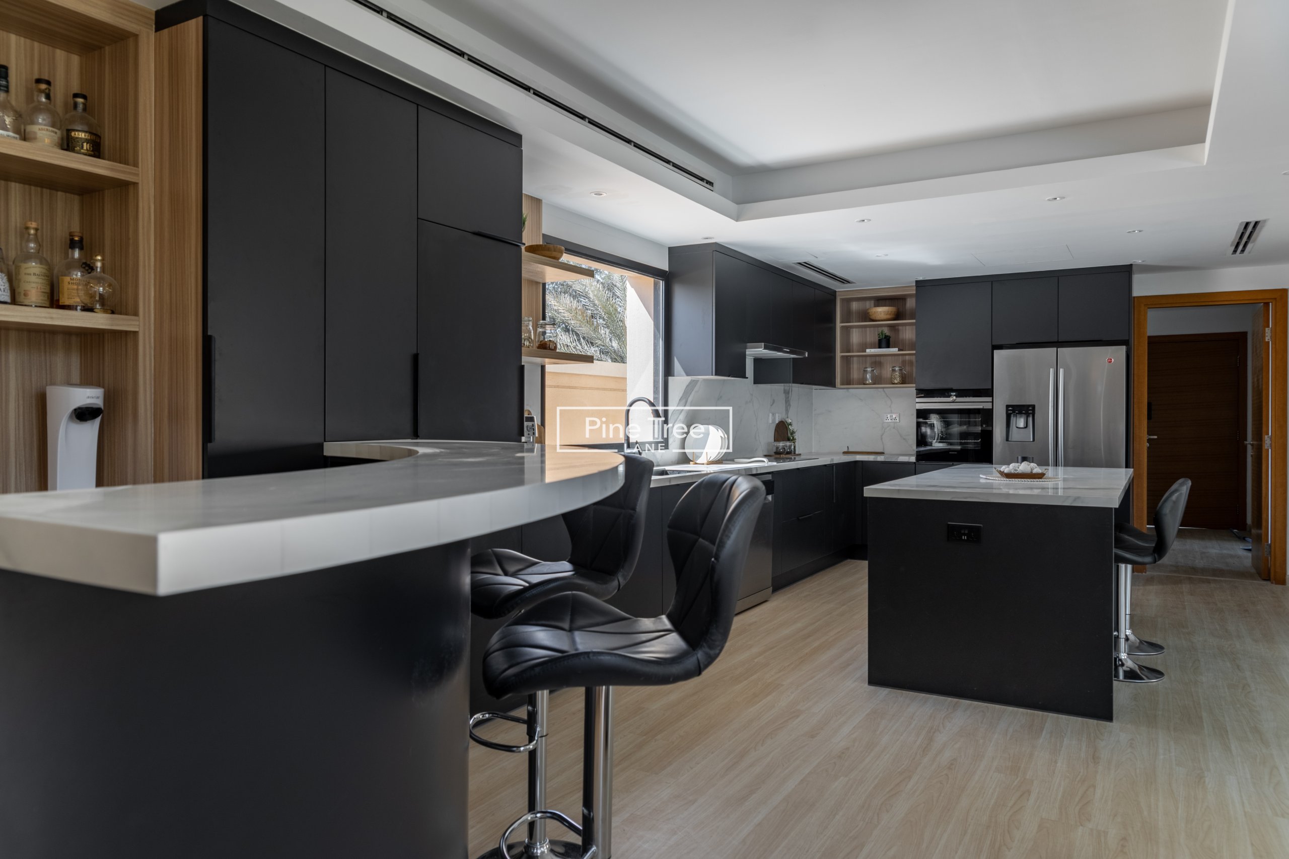Stylish kitchen with matte black cabinets and bar nook