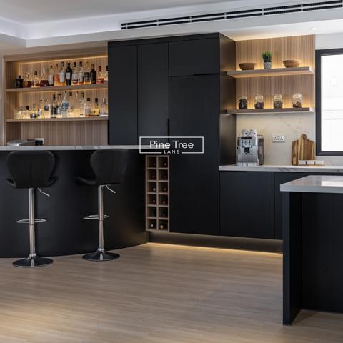 kitchen featuring matte black cabinets and built-in bar and coffee areas