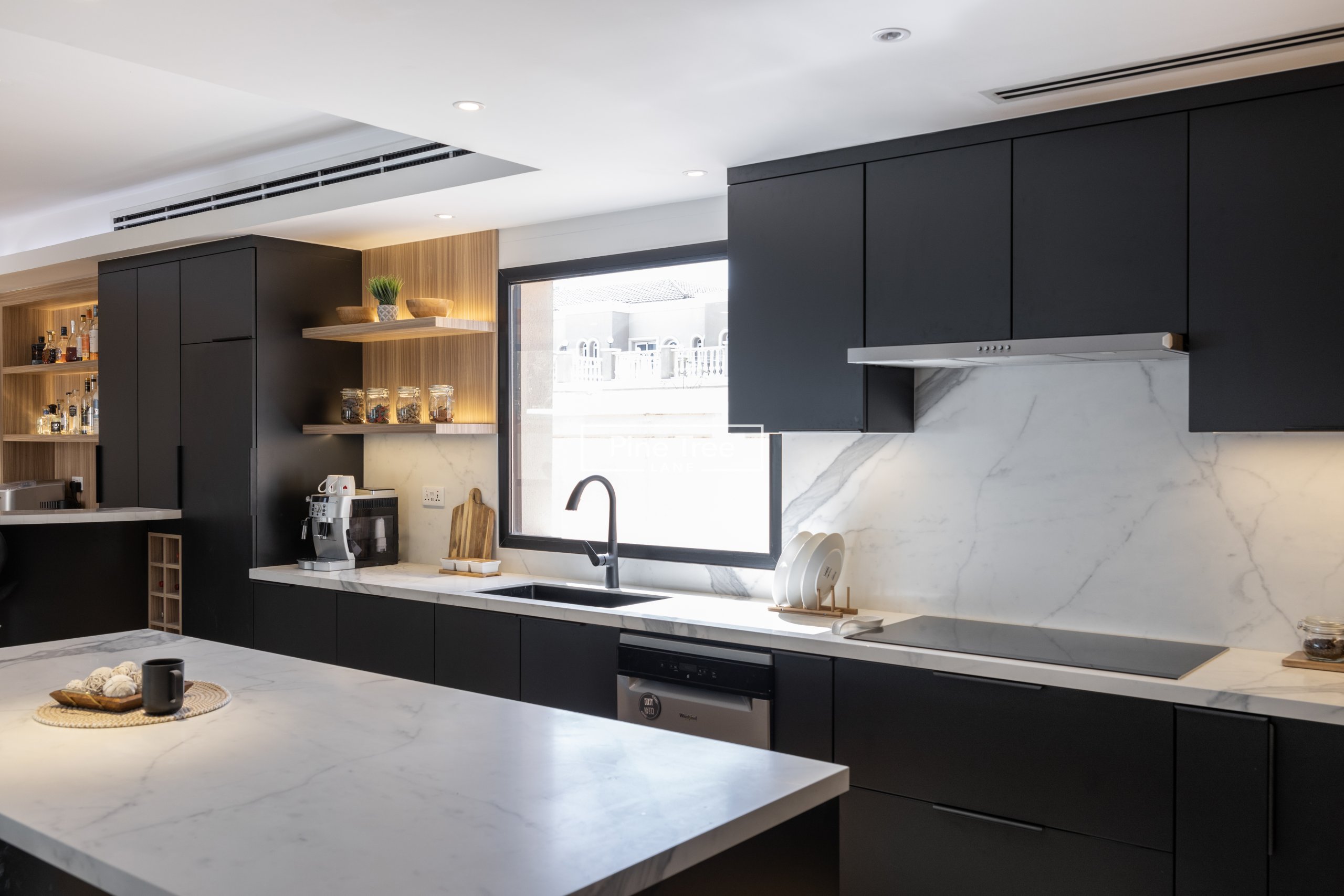 kitchen featuring black cabinetry and coffee corner