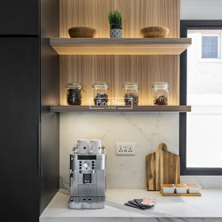 kitchen with black cabinetry and coffee stations.