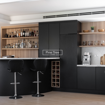 Kitchen Black cabinetry with island and bar area