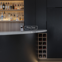 kitchen with matte black cabinets, marble countertops, and integrated bar
