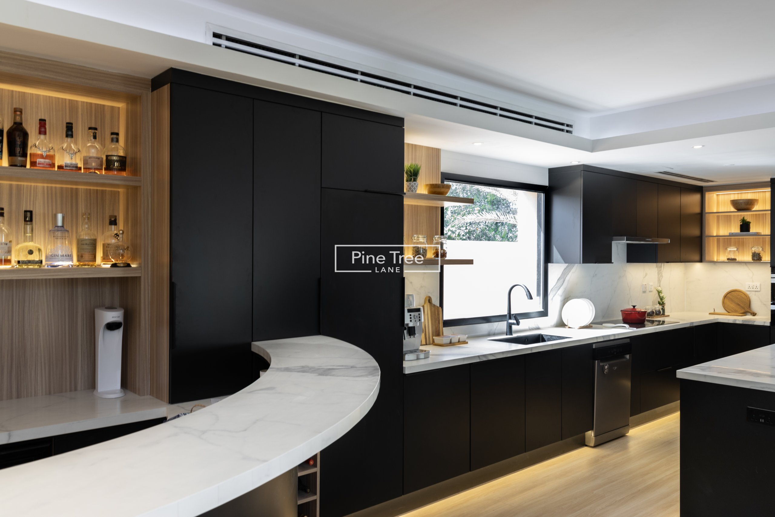 kitchen with matte black cabinets and marble top