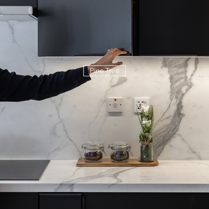 Close-up of marble countertop with matte black cabinets