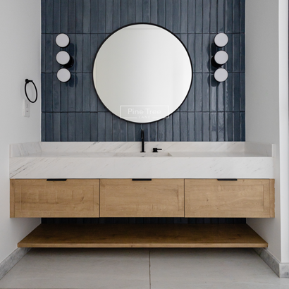 Floating oak vanity with marble top and round mirror