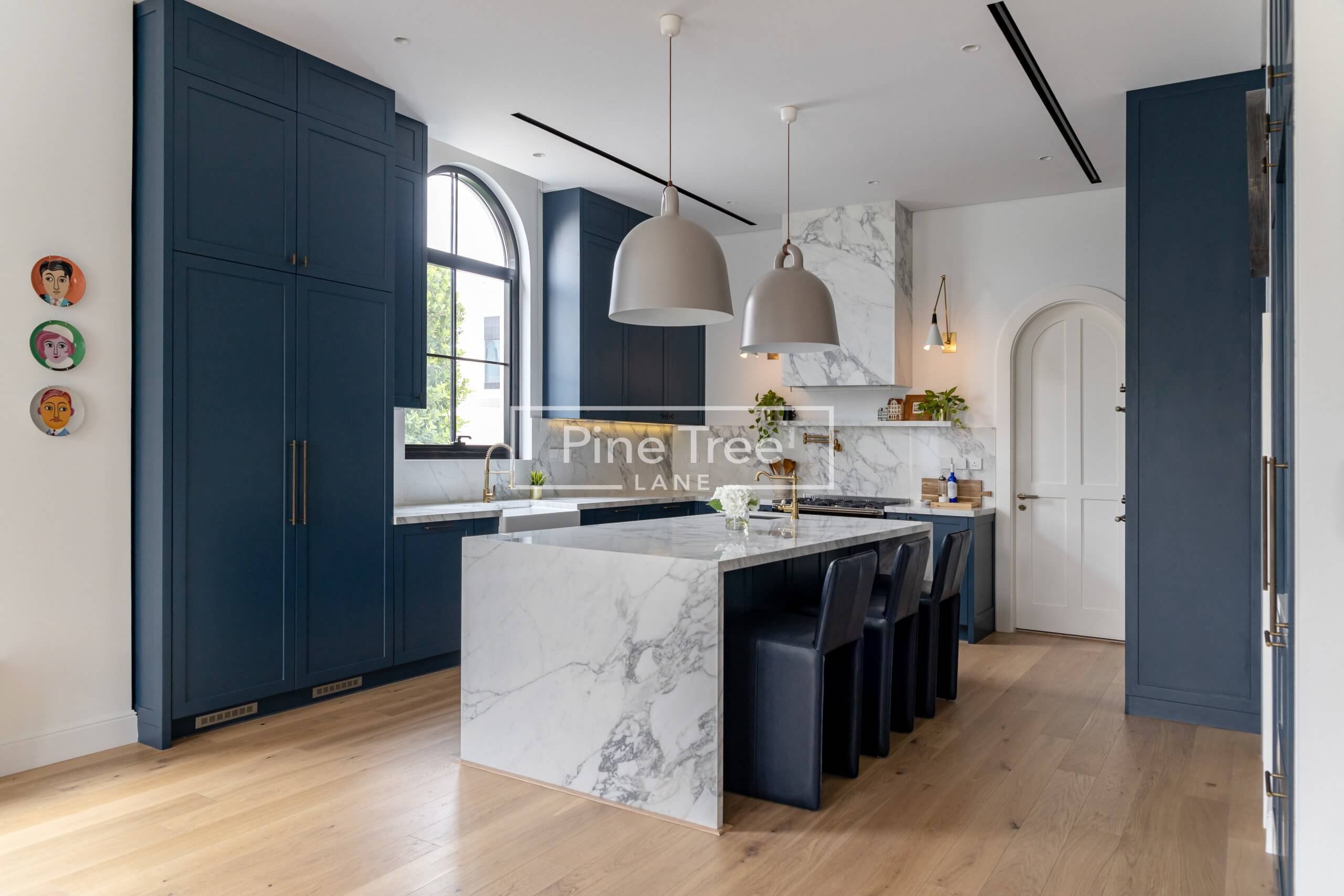 A kitchen with blue cabinetry
