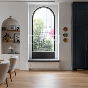 Living room with arched niches, white joinery, and modern decor