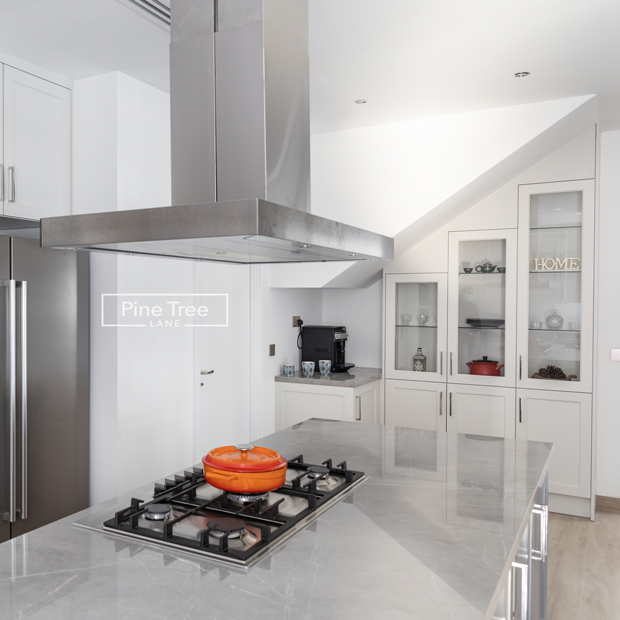 kitchen design featuring a sleek chimney over the cooking area