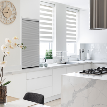 Sleek kitchen with built-in ovens and bar stools