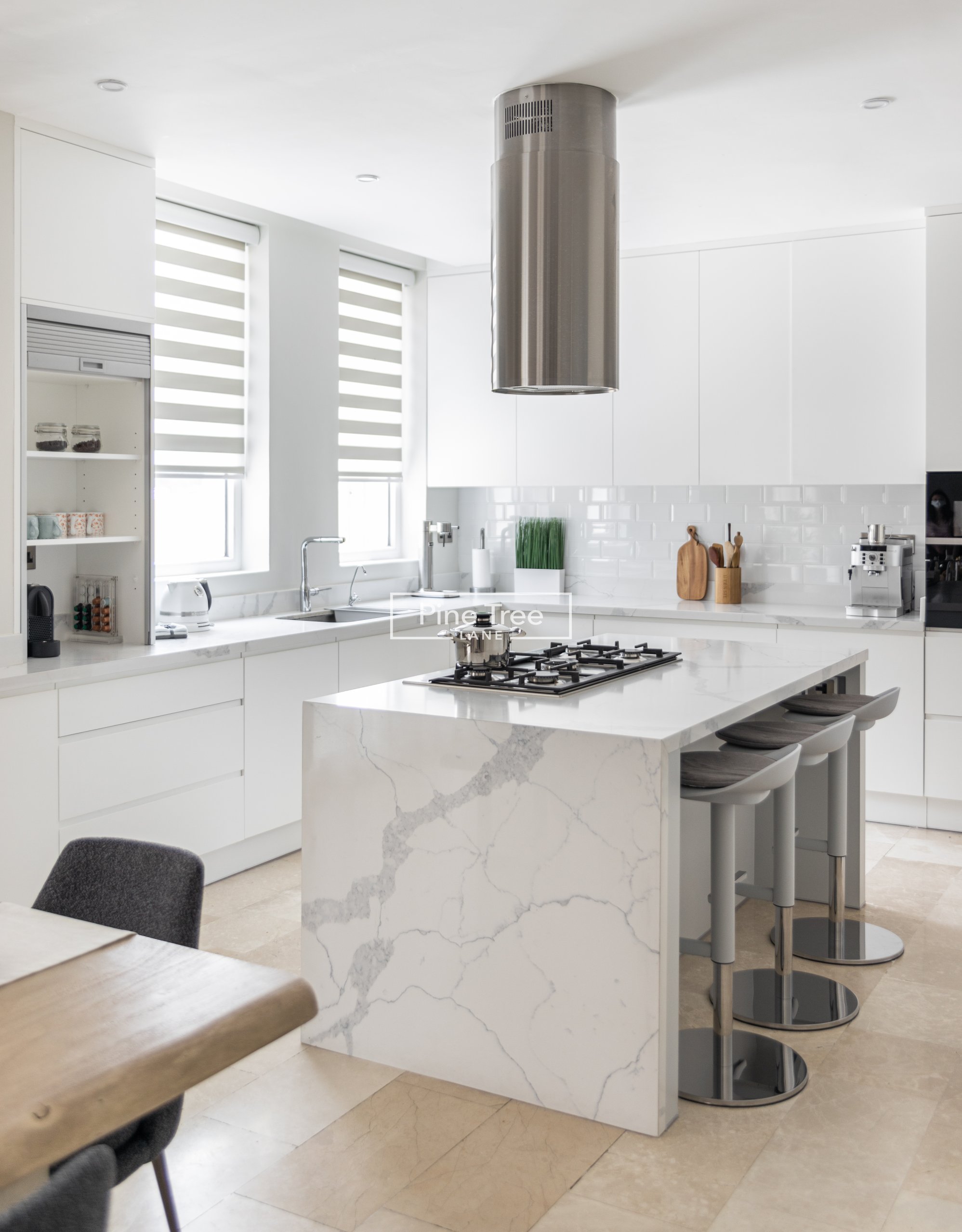 kitchen with white cabinetry and marble counters