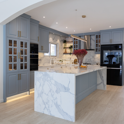 kitchen with blue cabinetry and marble counter