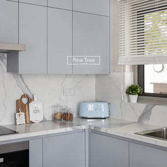 Modern kitchen featuring grey cabinets