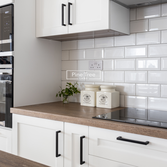 White kitchen cabinets with white tile backsplash