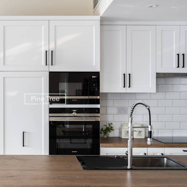 kitchen with white cabinets and natural textures