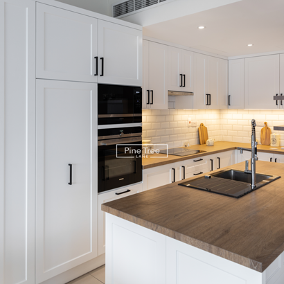 Modern kitchen with white cabinets and wooden worktop
