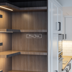 Bespoke kitchen with white cabinetry and wood textures