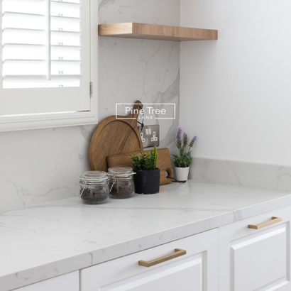Kitchen White cabinetry with open shelves and marble backsplash