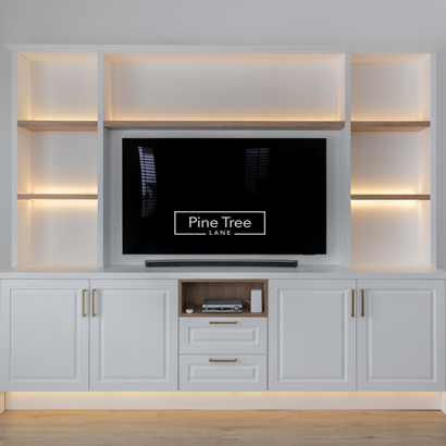 Media unit featuring oak shelves and soft ambient lighting