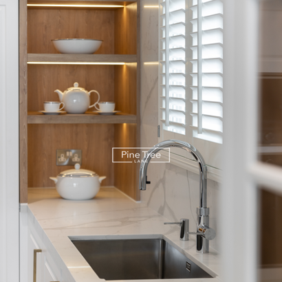 Shelves with lighting above marble countertop
