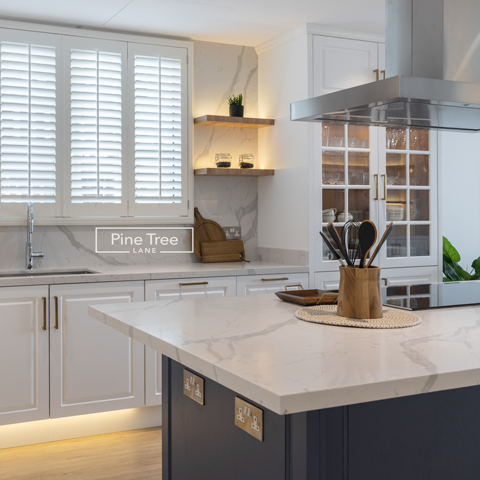 Modern navy kitchen cabinets under marble countertop