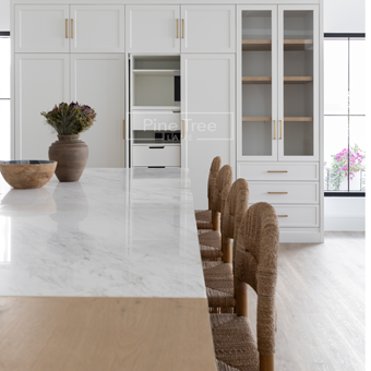 Coastal kitchen with quartz island and brass accents