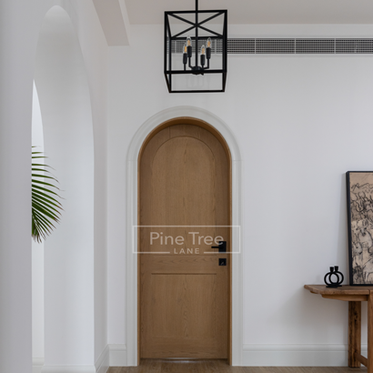 Custom arched wooden door with soft curves