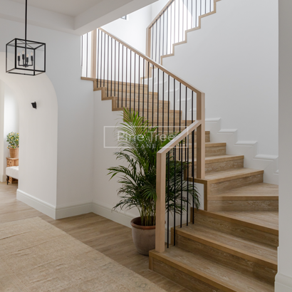 wooden staircase with black railing