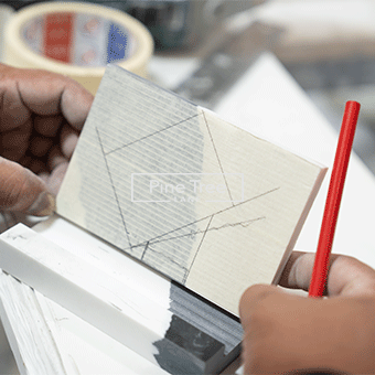 Craftsman drawing size measurements on a piece of marble