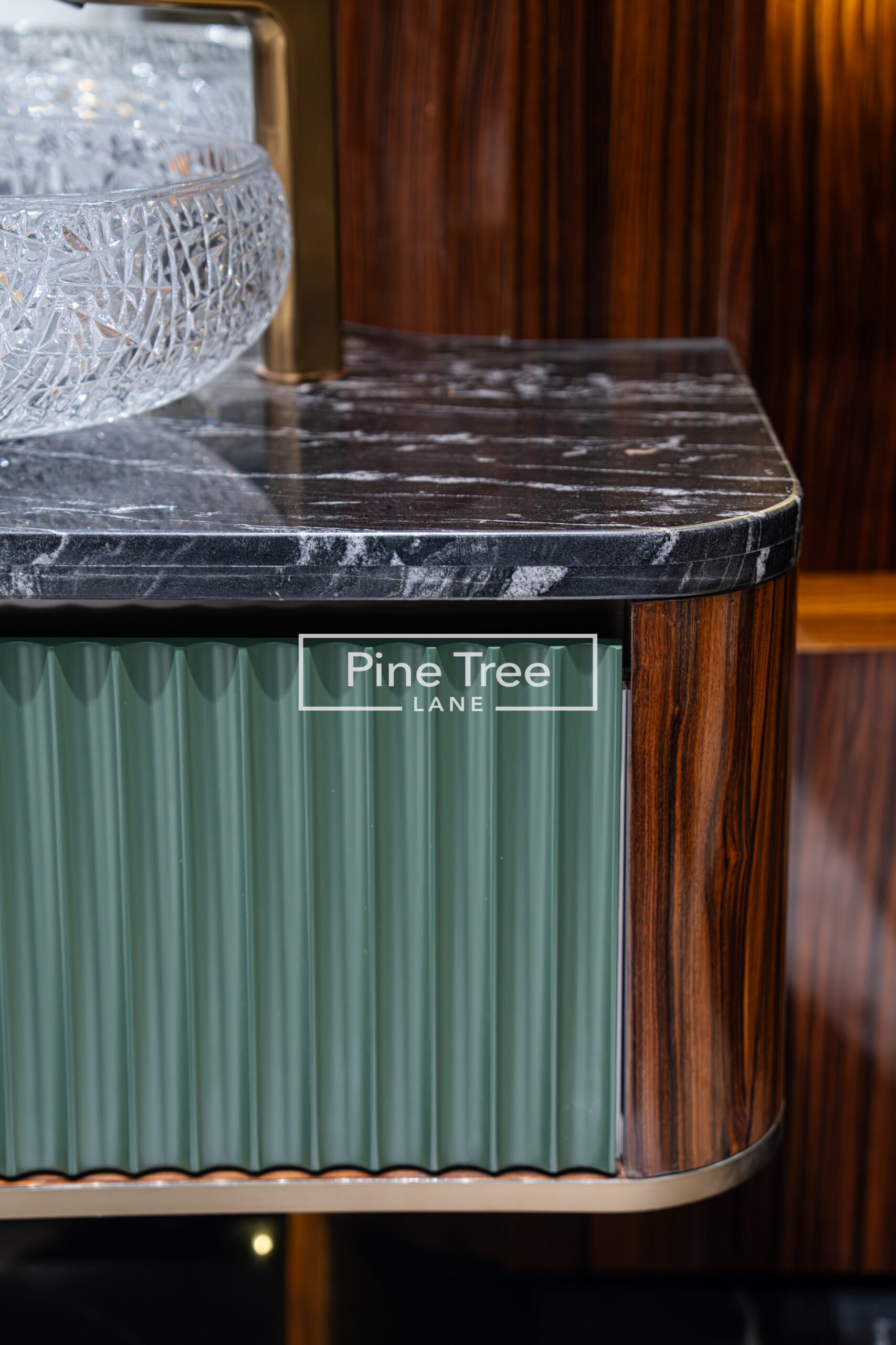 Close-up of custom cabinetry with black marble countertop