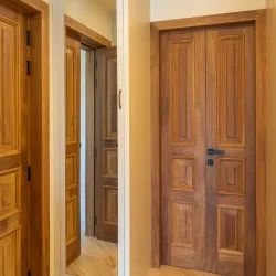 Solid wooden interior double doors with black metal handles