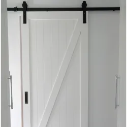Modern white wooden sliding barn door with black metal track hardware