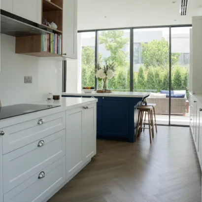 Modern bright kitchen with white island, custom cabinetry.