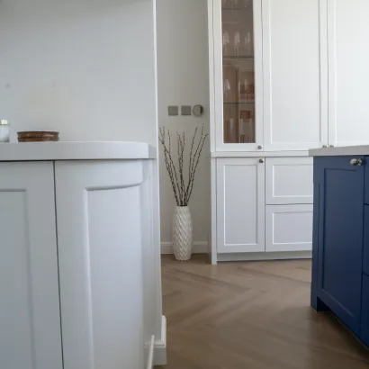 Modern white kitchen with central kitchen island and built-in white cabinetry