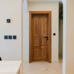 Custom crafted wooden door installed in a modern hallway